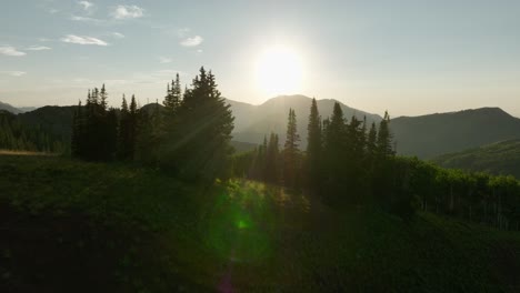 Aerial-over-backcountry-mountain-range-and-forest-at-sunset-1