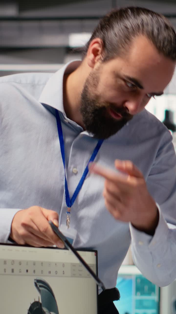 Manager overseeing engineer using CAD app to optimize wind turbine design