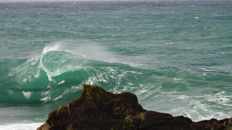 heavy wave fans out with backwash as it breaks during a winter storm