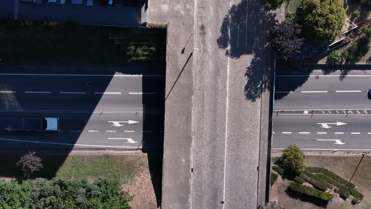 Aerial view of roads crossing with cars driving by