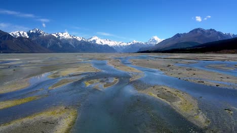 epic aerial push-in over the tasman river towards mt cook, new zealand's highest peak