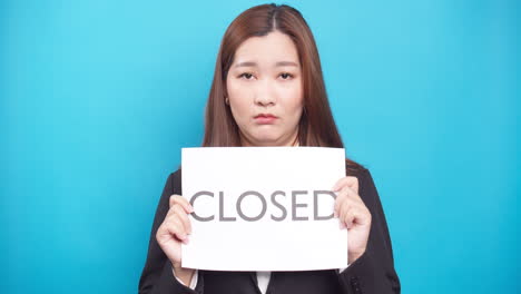 businesswoman holding paper the text closed with face sad in financial crisis and copy space