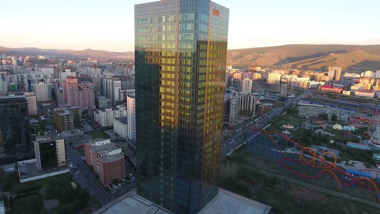 drone aéreo disparado de cerca vidrioso edificio de lujo durante el atardecer mongolia