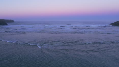 Tidal-ebb-flow-on-isolated-Cantabrian-beach-Spanish-coast-sunset-AERIAL