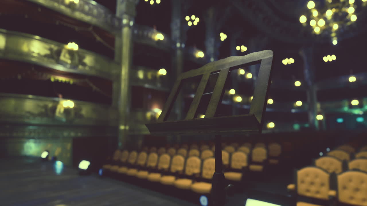 Concert hall with empty seats and music stand in focus during evening event