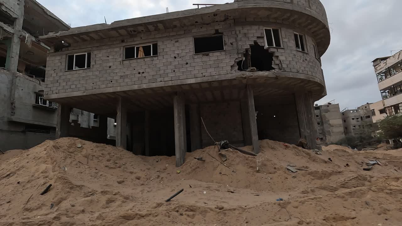 Camera reveals aftermath of destroyed city Gaza after airstrike, missile attack during Israel Hamas War 2023, Military vehicle driving through the bombarded streets of Gaza