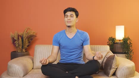 Man-meditating-looking-at-camera.