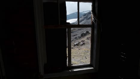 broken window view of mountain landscape