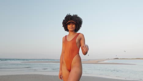 cute mulatto model posing at the beach in a bikini set