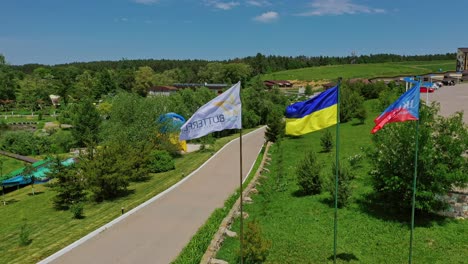 ukrainian flag in the wind. aerial view of national flag of ukraine flies in the blue sky