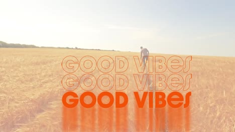 animación de las palabras buenas vibraciones escritas en naranja con un hombre caminando en un campo de maíz iluminado por el sol