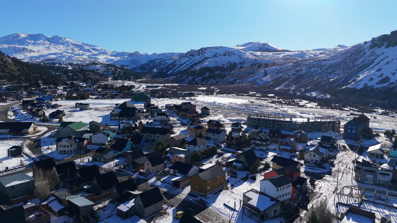 Aerial Drone fly Caviahue Valley, Snowy Andes Peaks, Patagonian Homes of Neuquen, Argentina, Establishing view