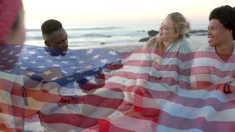 Animation-of-flag-of-usa-over-happy-diverse-friends-on-beach-in-summer