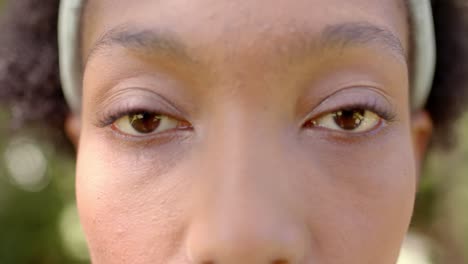 portrait of happy african american woman in garden, in slow motion