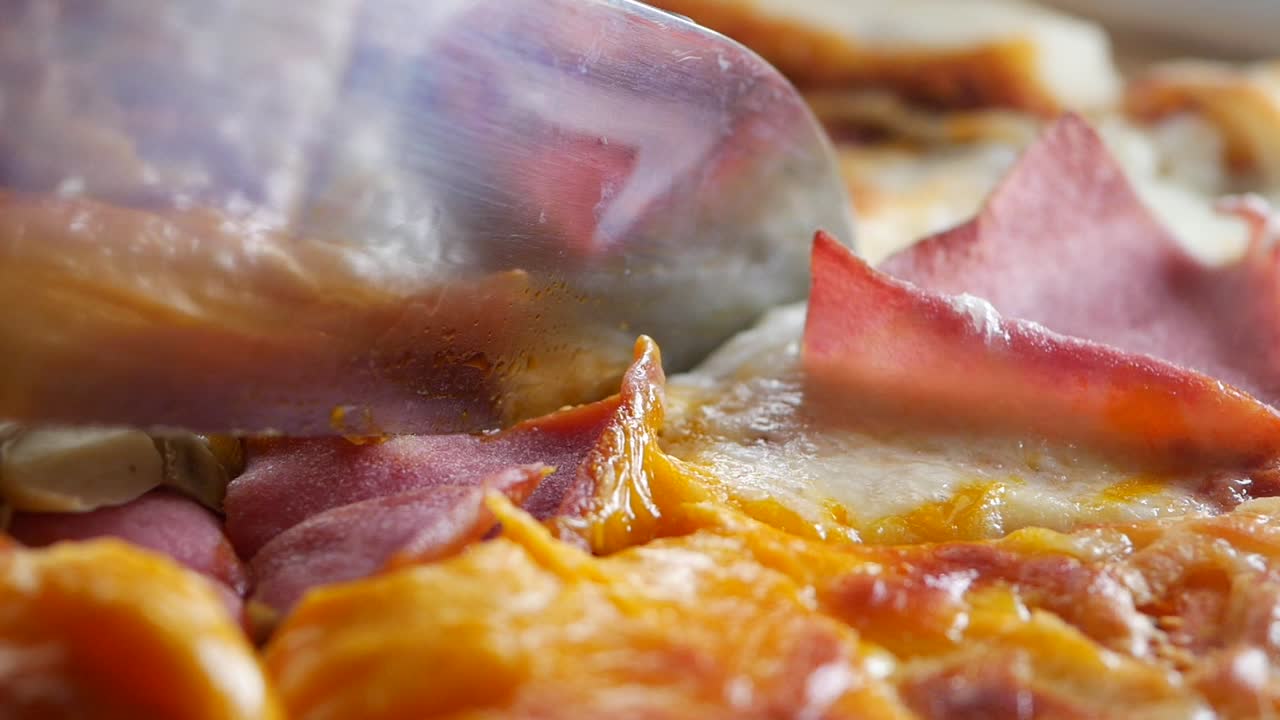 Close-up of pizza with ham and cheese