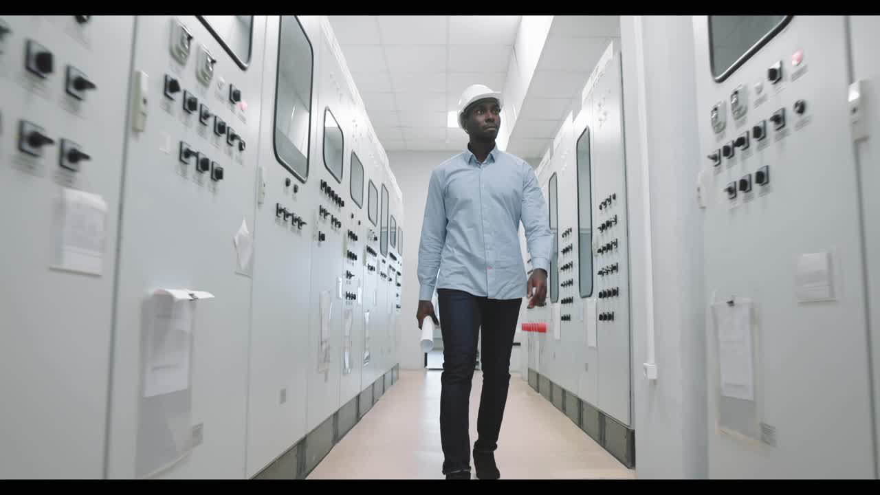 Engineer Walking Through Power Plant Control Room