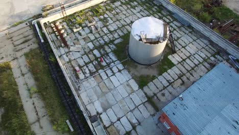 aerial view of an industrial facility with a concrete oil tank