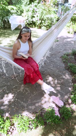 girl reading in a garden hammock