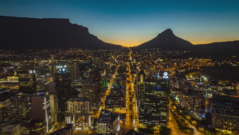 Evening-aerial-hyperlapse-shot-of-downtown.-Silhouette-of-mountain-ridge-in-background.-South-Africa
