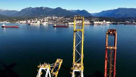 closeup of industrial port cranes at container terminal on vancouver harbour in canada