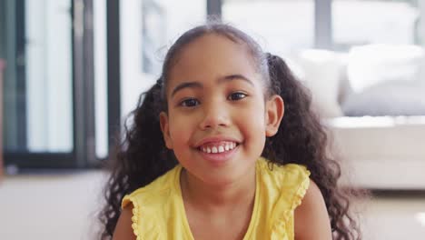 Portrait-of-happy-biracial-girl-looking-at-camera