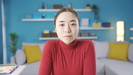 Young-Asian-woman-looking-at-camera-tired-and-unhappy.