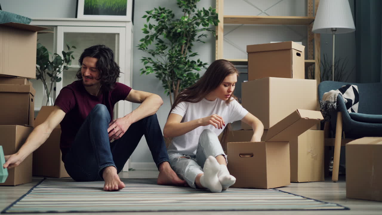 Couple Unpacking Boxes in a New Home