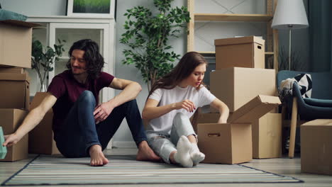 couple unpacking boxes in a new home