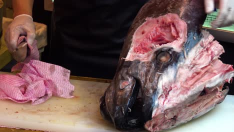 man preparing tuna fish for sushi