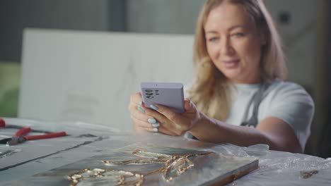 woman taking a picture of her artwork