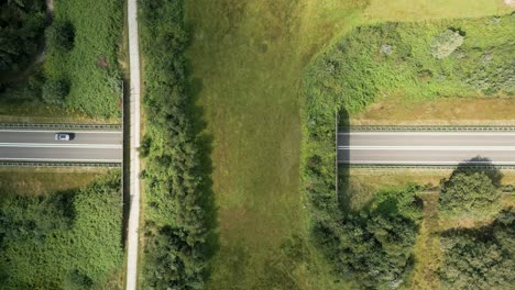 aerial view of roads and bridges crossing through green landscape
