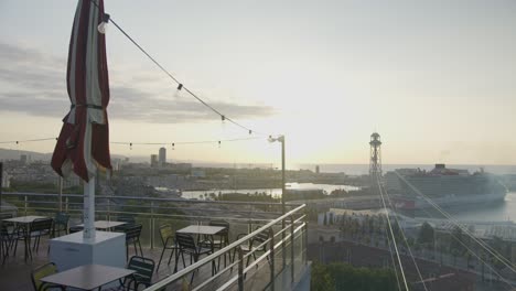 cafe ledge second view, barcelona spain city skyline with golden sunrise in 6k as birds fly