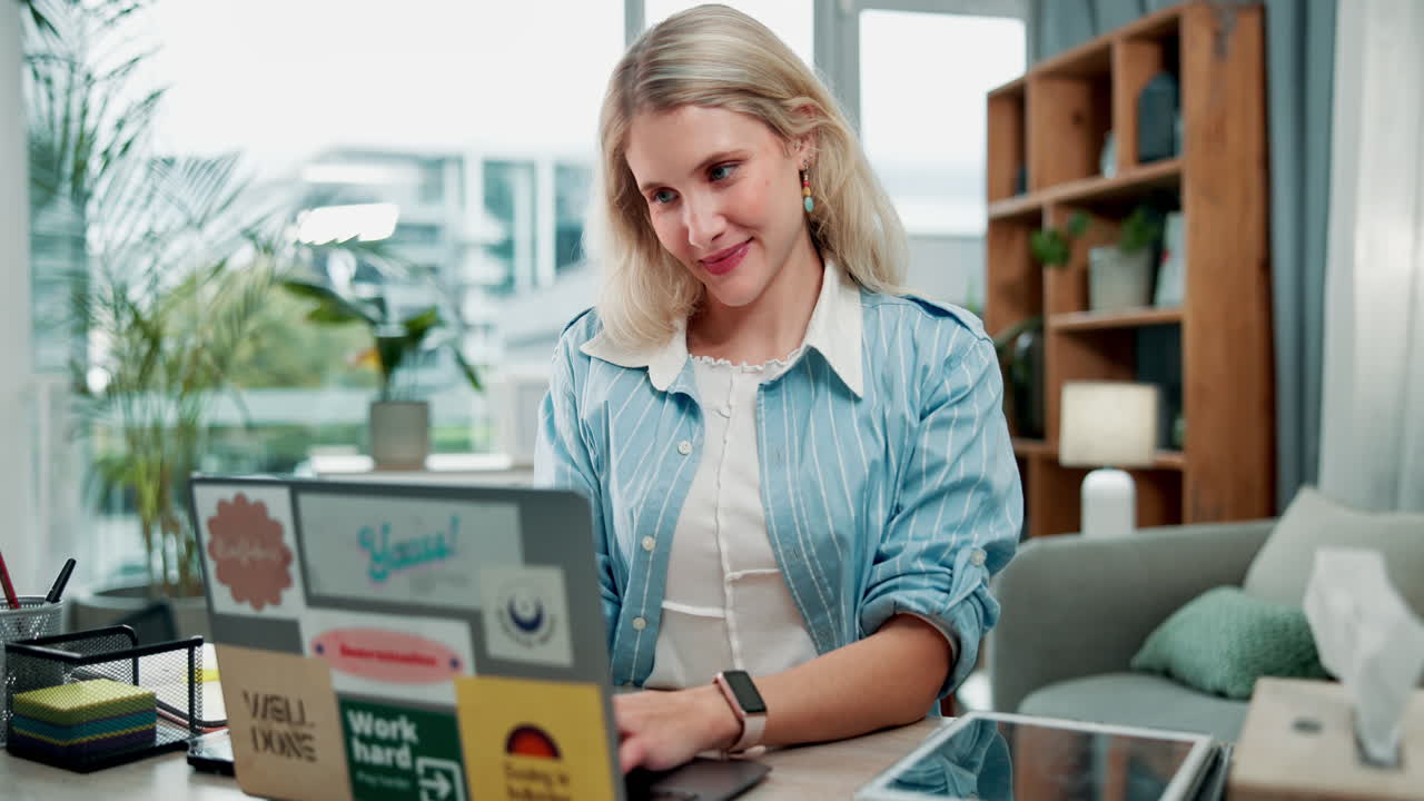 A woman is coughing while using a laptop
