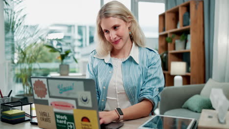 a woman is coughing while using a laptop