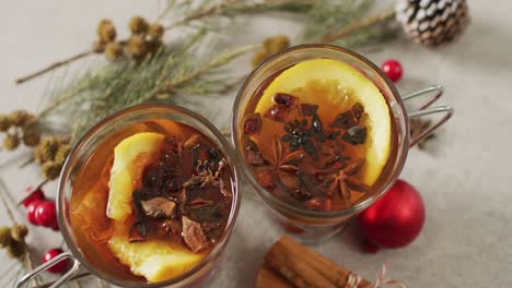 video of cups of hot tea with cinnamon and lemon over white background