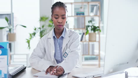 Black-woman,-doctor-and-writing-paper-by-computer