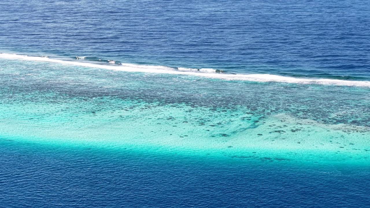 French Polynesia, Drone Shot of Coral Reefs Barrier, Waves and Lagoon South Pacific Ocean