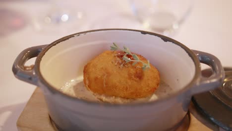 delicious spanish croquette in truffle sauce served in a ceramic bowl at gourmet restaurant