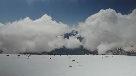 high-altitude mountain scenery with clouds and snow