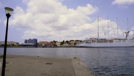 cruise ship docked at a colorful harbor town
