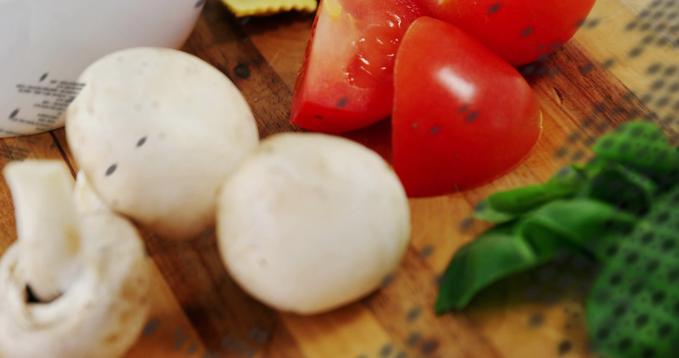 Food on board reacting to dotted sweep, camera panning, focusing mushrooms and tomatoes for food ad