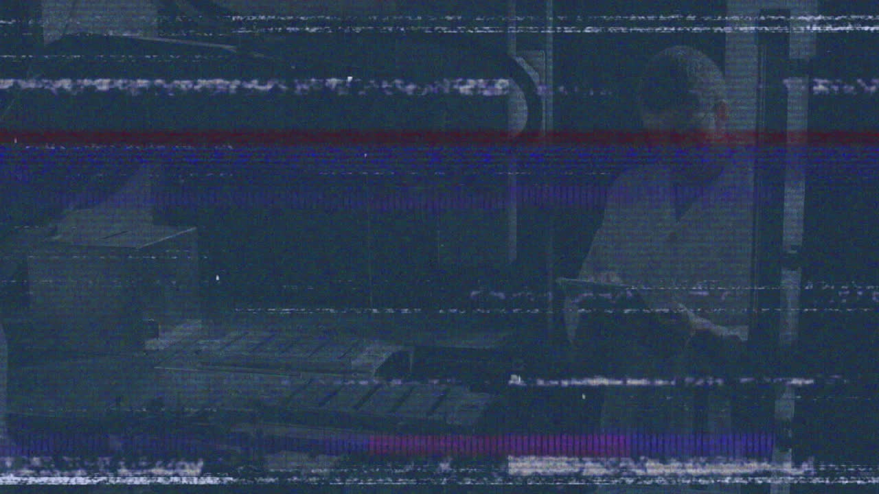 In dark room, animation showing person in lab coat working with static lines