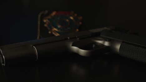 wide view of a pistol and police badge