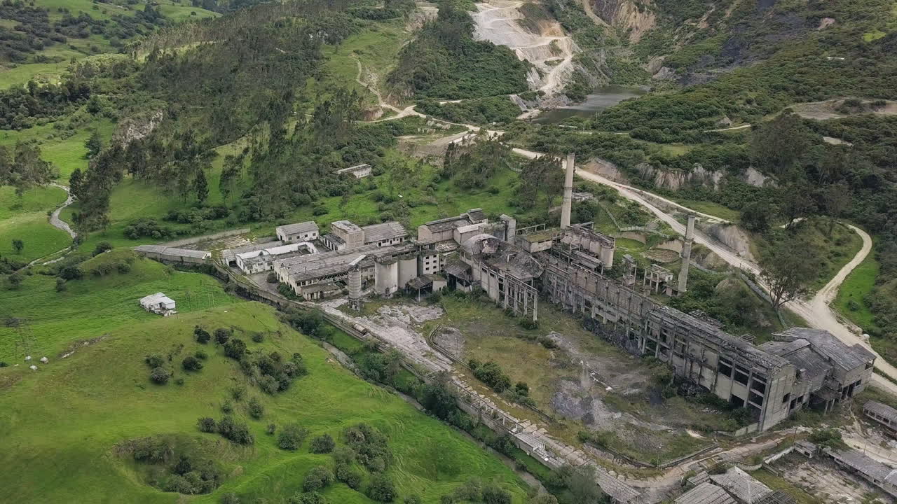 Slow aerial fly away showing the full scale of the abandoned cement plant near La Calera, Colombia.