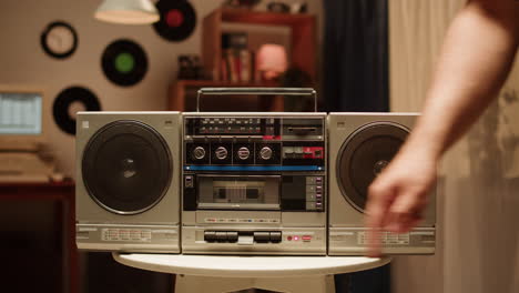 person using a vintage boombox