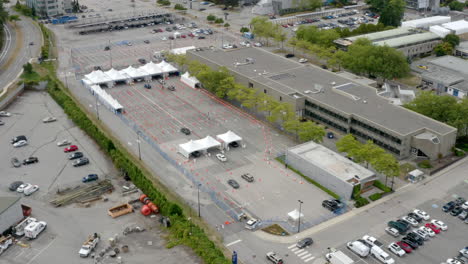 Aerial-View-Of-Vehicles-Driving-On-Tents-At-Drive-Thru-COVID-19-Vaccine-Site