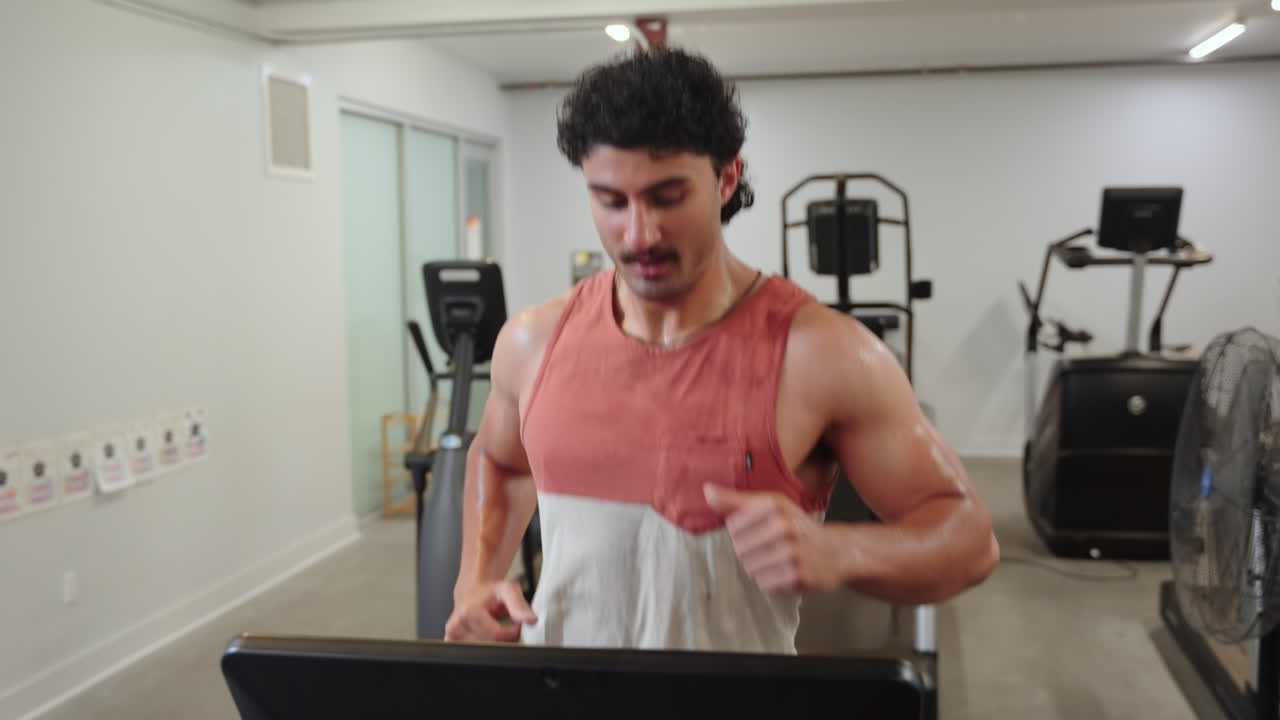Man Running On A Treadmill In The Gym - Close Up