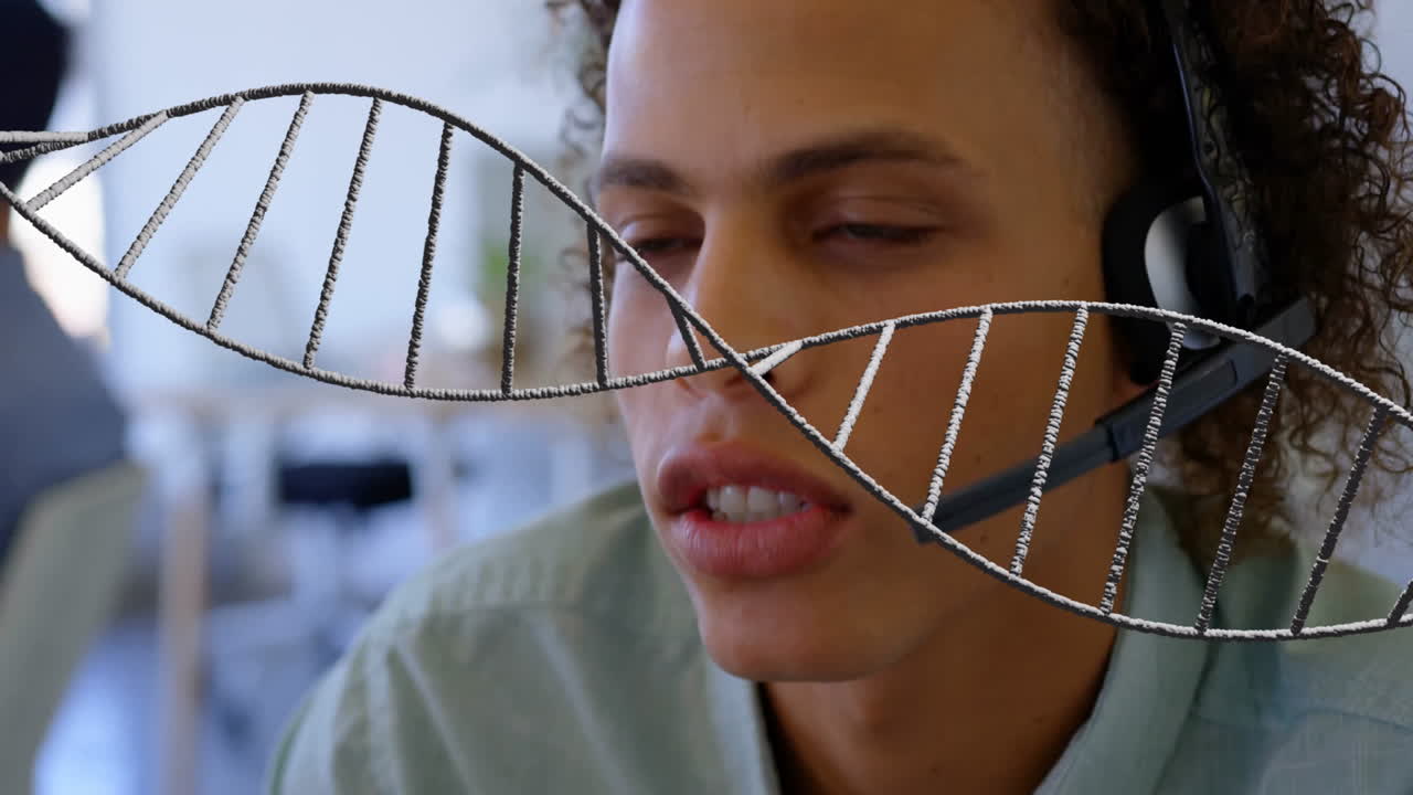 DNA strand animation over person wearing headset in office setting