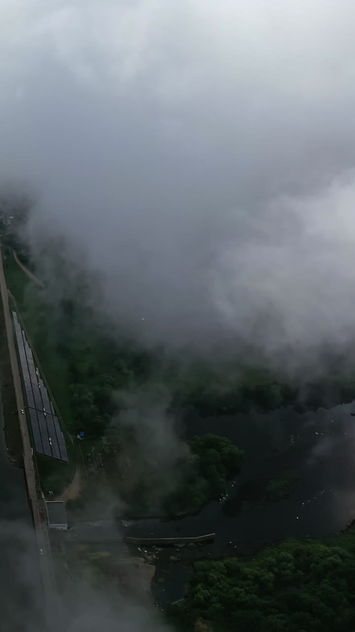 Flying in the clouds. View from the sky on beautiful nature background. White clouds are moving. Natural landscape from the air among fluffy clouds. Aerial view. Vertical video