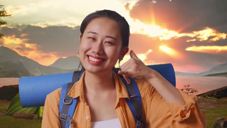 happy woman traveler gesturing call at sunset